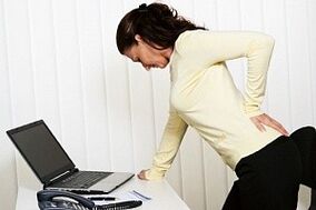 the woman has back pain in the lumbar region